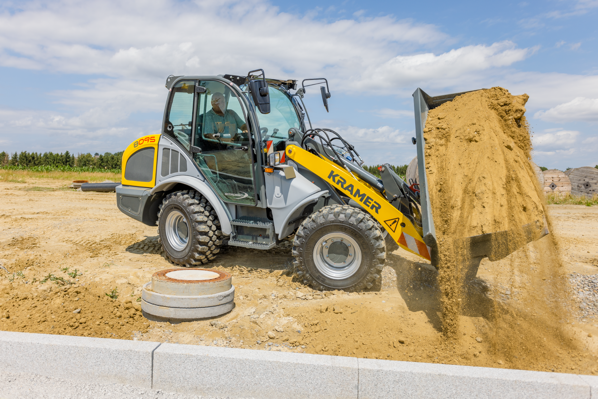 The Kramer wheel loader 8095 while working with soil.