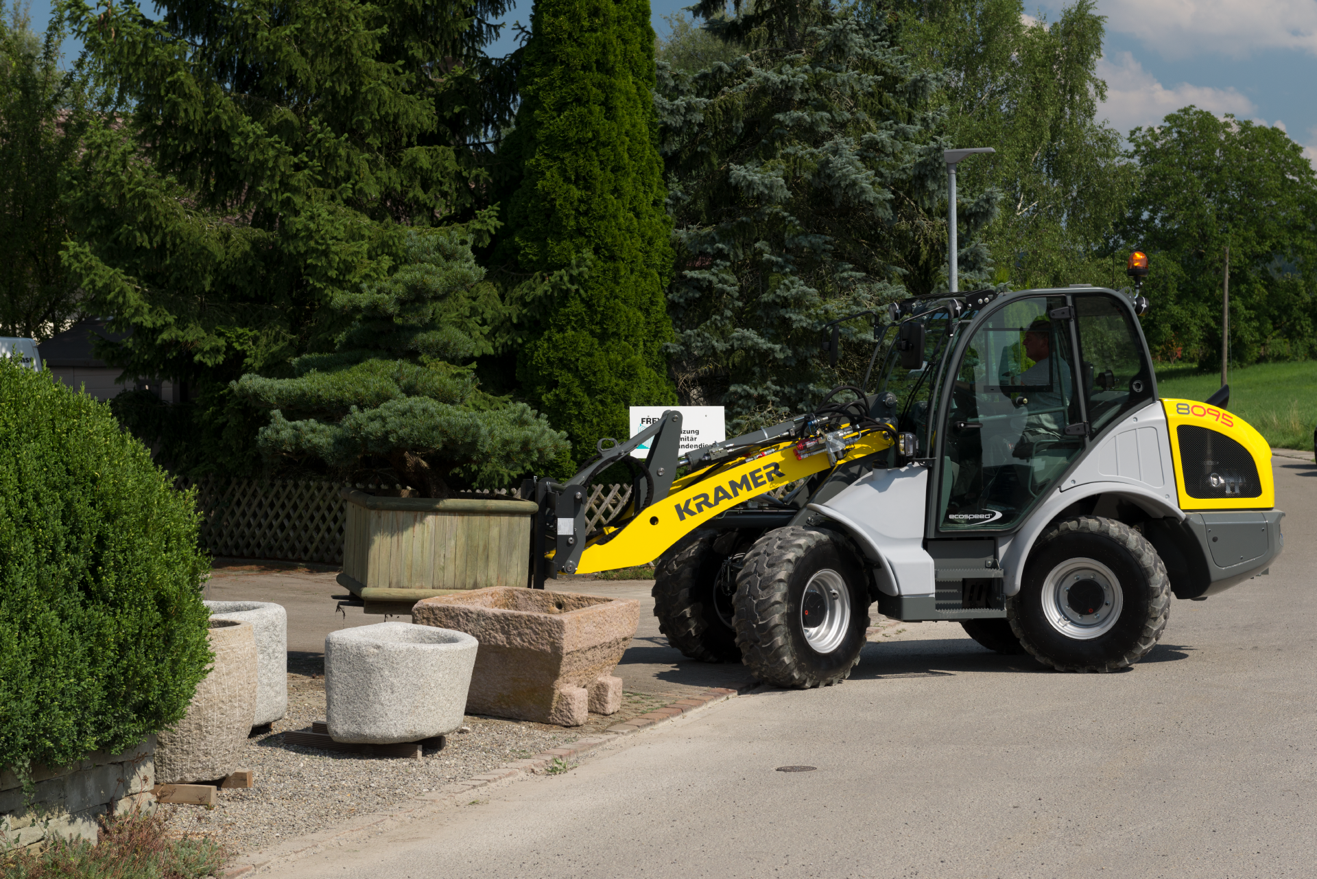 The wheel loader 8095 transporting a flower box.