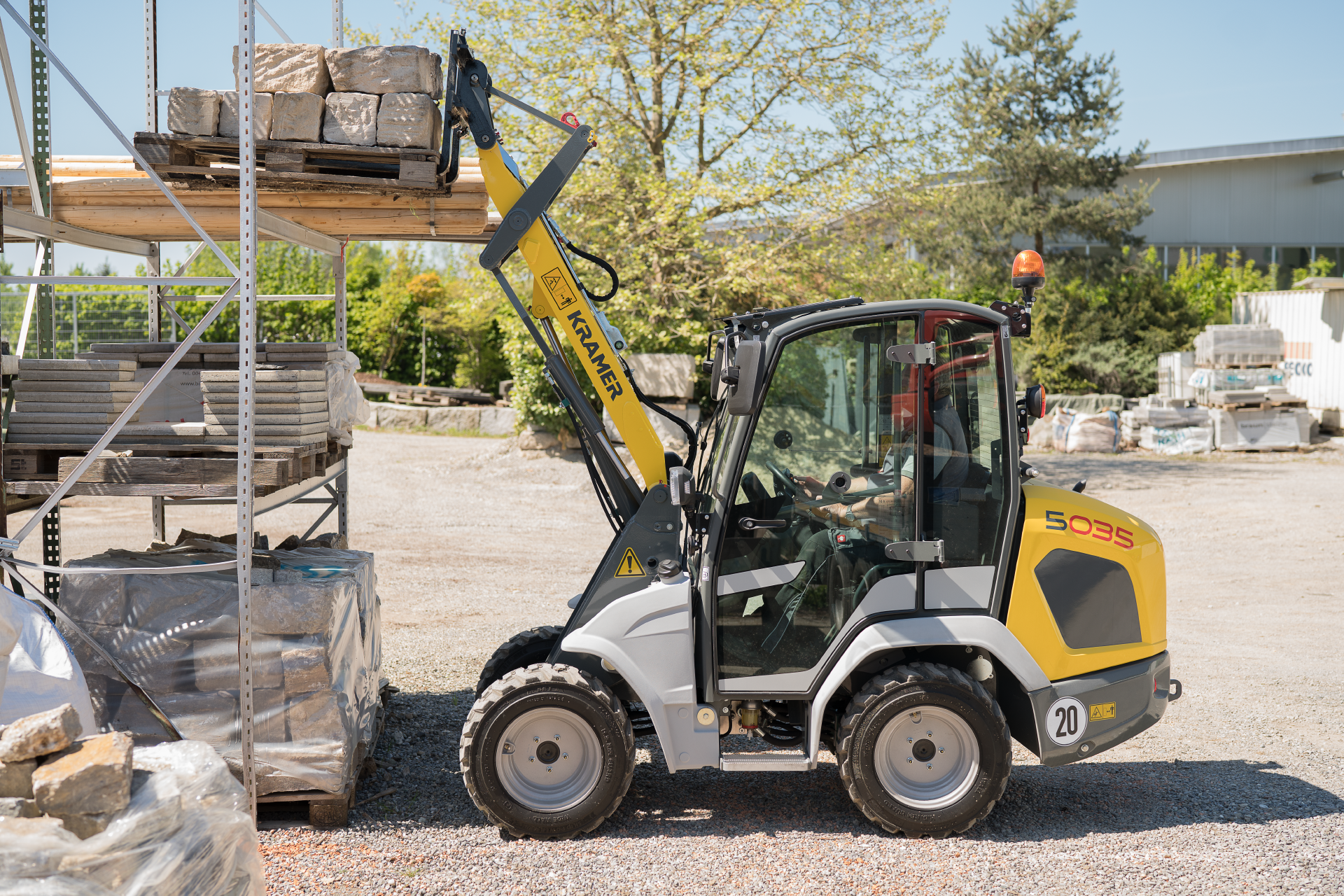 The compact 5035 while loading a stone pallet.
