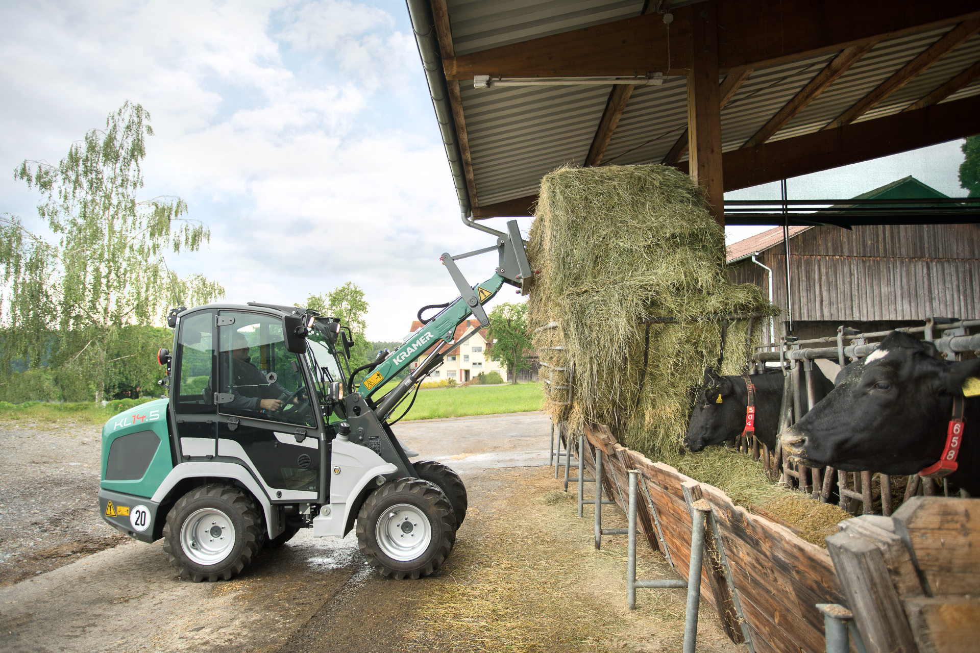 The compact KL14.5 while loading straw for the animal feeding.