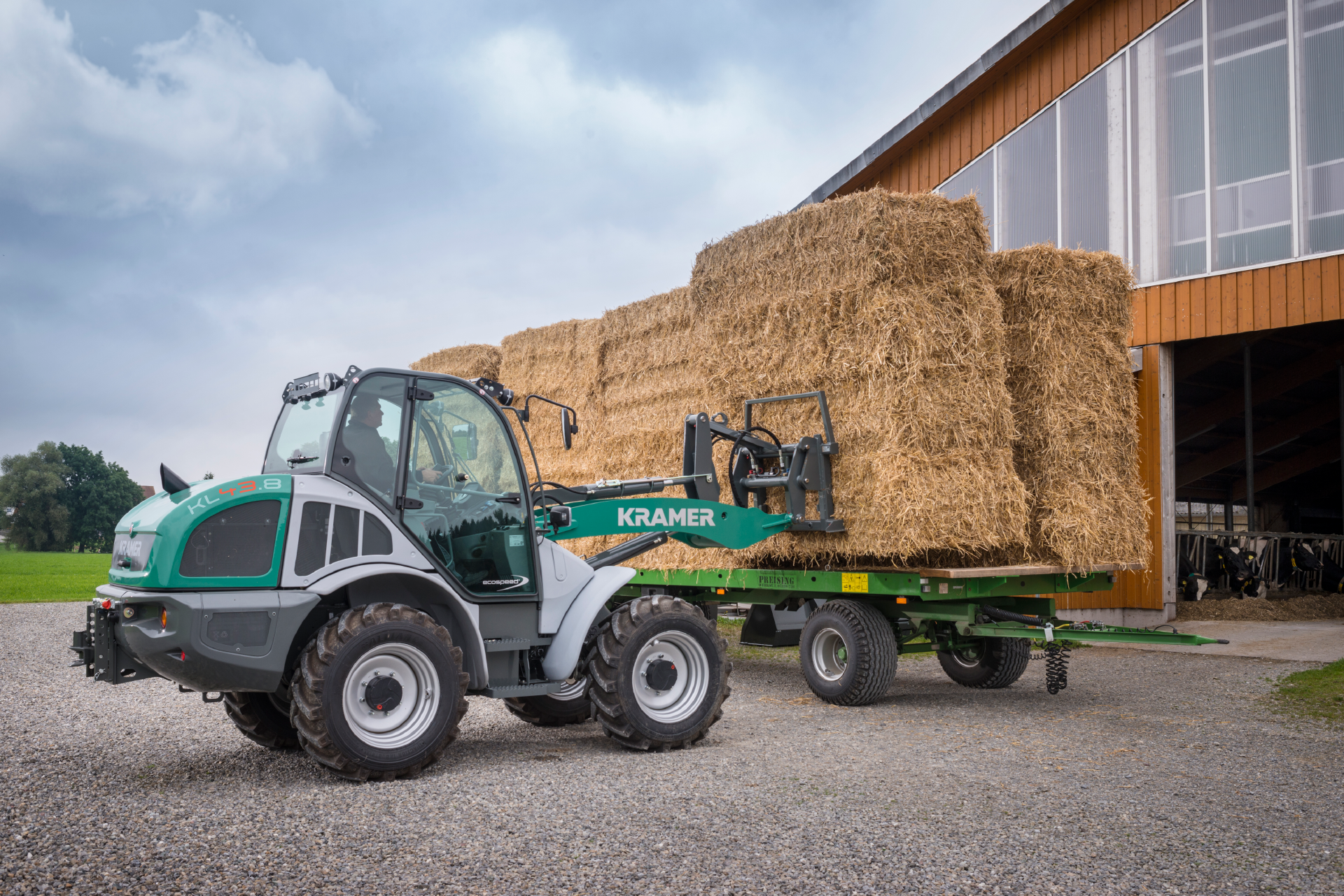 The Kramer wheel loader KL43.8 while transporting, loading and stacking straw.