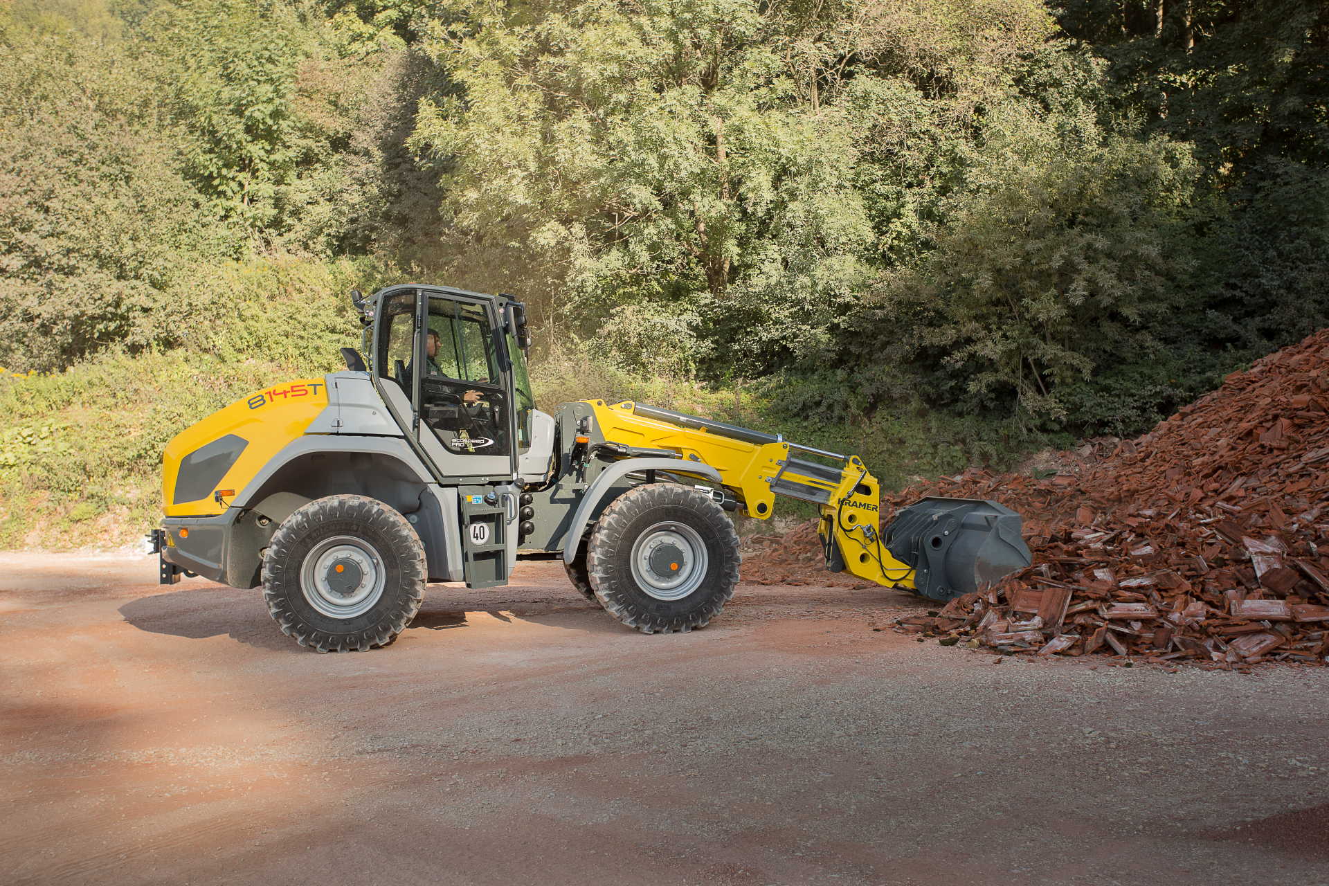 The Kramer telescopic wheel loader 8145T while working with wood chips.